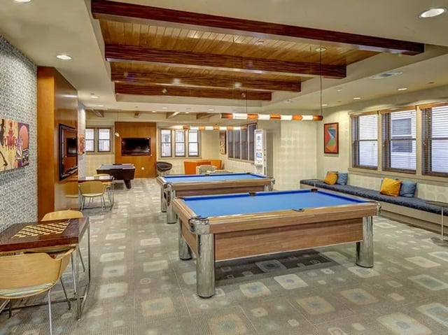 Two pool tables and a checkerboard table leisure area at Camino del Sol in Irvine Student Accommodation