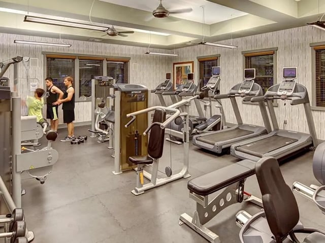 Treadmills machines and people working out gym at Camino del Sol in Irvine Student Accommodation