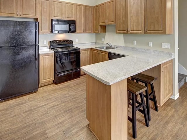 Refrigerator stove microwave cabinets breakfast bar kitchen at Camino del Sol in Irvine Student Accommodation