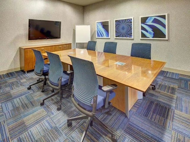 Conference table with chairs and TV meeting room at Camino del Sol in Irvine Student Accommodation