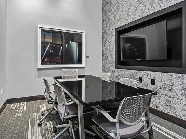 Black table chairs mounted TV study area at Chestnut Square in Philadelphia Student Accommodation