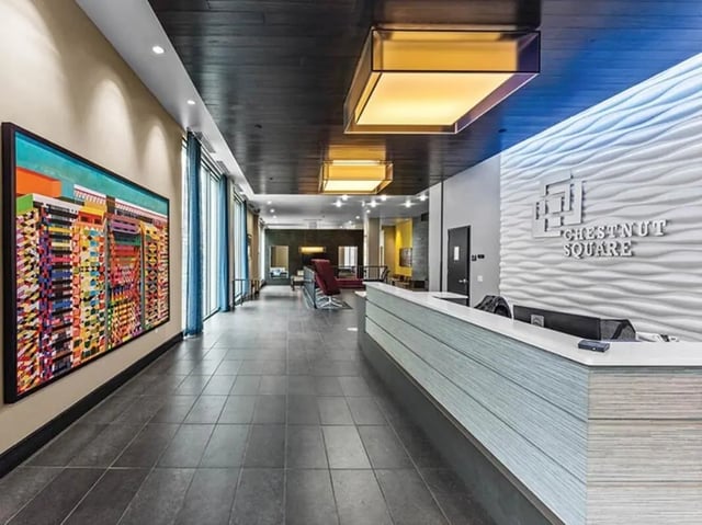 Reception desk artwork lighting and seating lobby at Chestnut Square in Philadelphia Student Accommodation