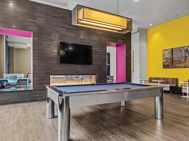 Pool table television fireplace and couches living room at Chestnut Square in Philadelphia Student Accommodation