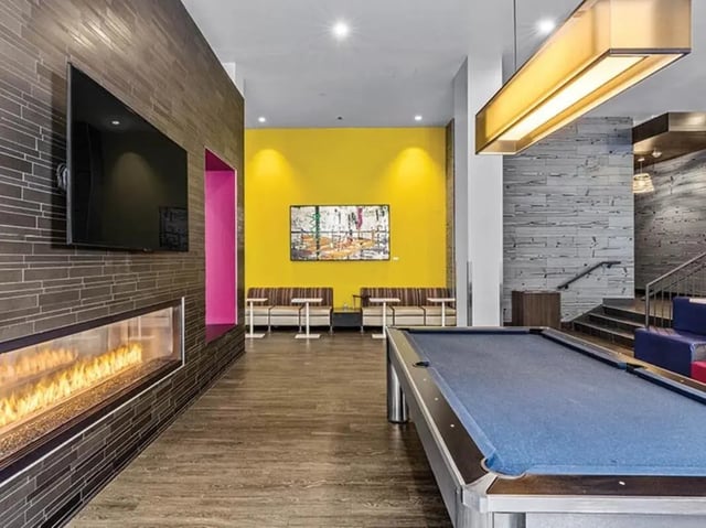Pool table fireplace couches painting lounge area at Chestnut Square in Philadelphia Student Accommodation