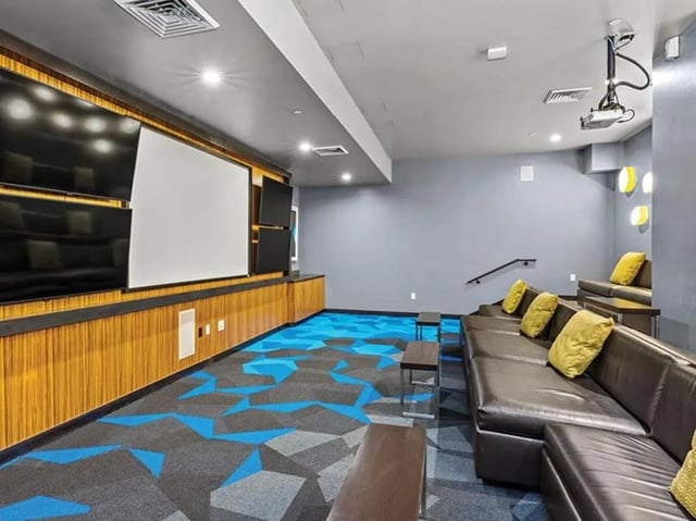 Screens sofas projector and patterned carpet playing area at Chestnut Square in Philadelphia Student Accommodation
