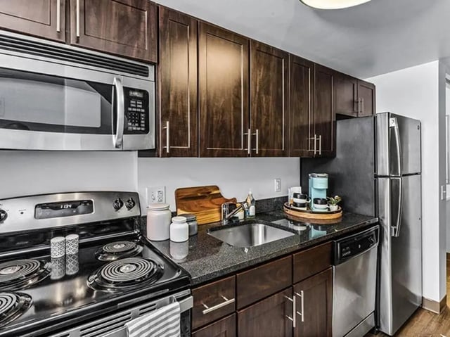 Modern kitchen with dark cabinets stainless steel appliances kitchen at Chestnut Square in Philadelphia Student Accommodation