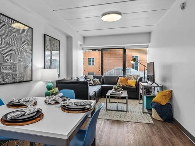 Dining table sectional couch living room at Chestnut Square in Philadelphia Student Accommodation