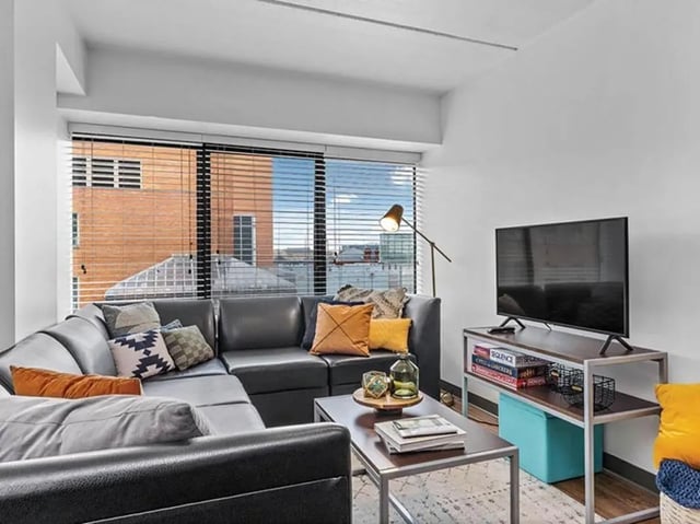 Grey sectional sofa and TV living room at Chestnut Square in Philadelphia Student Accommodation