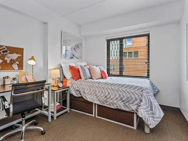 Desk bed with pillows and nightstand bedroom at Chestnut Square in Philadelphia Student Accommodation