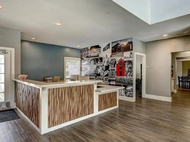 Reception desk with collage wall and furniture Lobby at Aggie Station in Bryan Student Accommodation