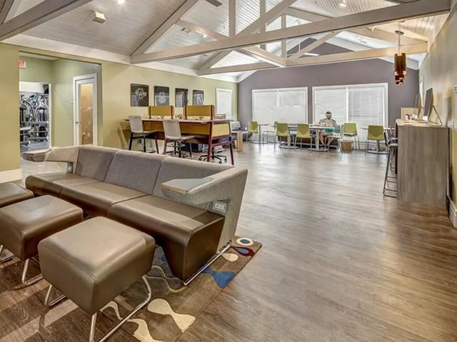 Sofa ottomans study desks and tables common area at Aggie Station in Bryan Student Accommodation