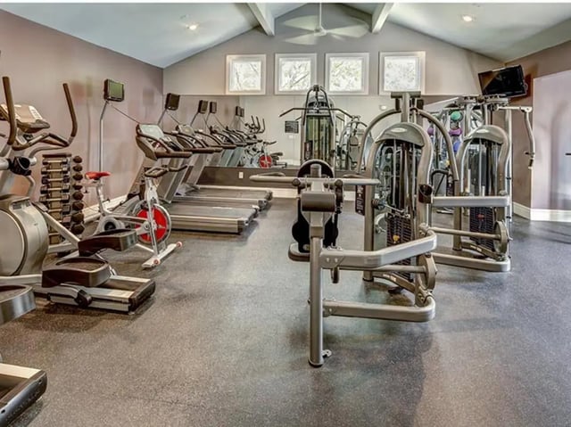 Gym with treadmills exercise bikes weight machines fitness gym at Aggie Station in Bryan Student Accommodation