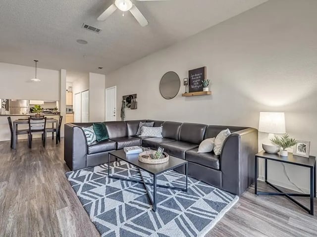 Sofa dining table and kitchen living room at Aggie Station in Bryan Student Accommodation