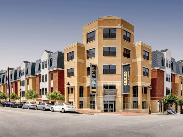 Apartment building with cars and banners exterior at 1200 West Marshall in Richmond Student Accommodation