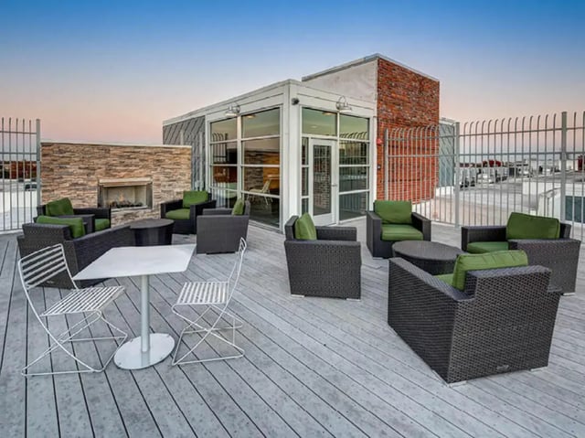 Outdoor seating area with tables chairs fireplace living area at 1200 West Marshall in Richmond Student Accommodation