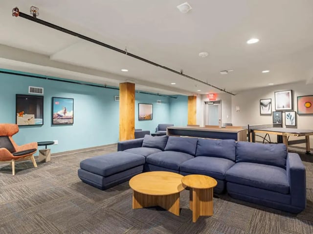Blue sectional sofa coffee tables ping pong table lounge at 1200 West Marshall in Richmond Student Accommodation