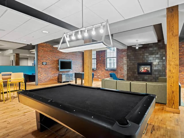 Billiard table sofas television fireplace lounge area at 1200 West Marshall in Richmond Student Accommodation