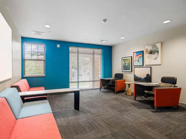 Sofa desks chairs artwork community room at 1200 West Marshall in Richmond Student Accommodation