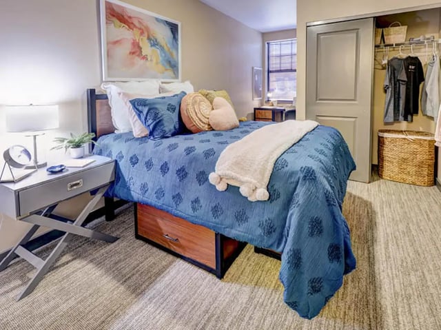 Blue patterned bed white blanket closet bedroom at 1200 West Marshall in Richmond Student Accommodation