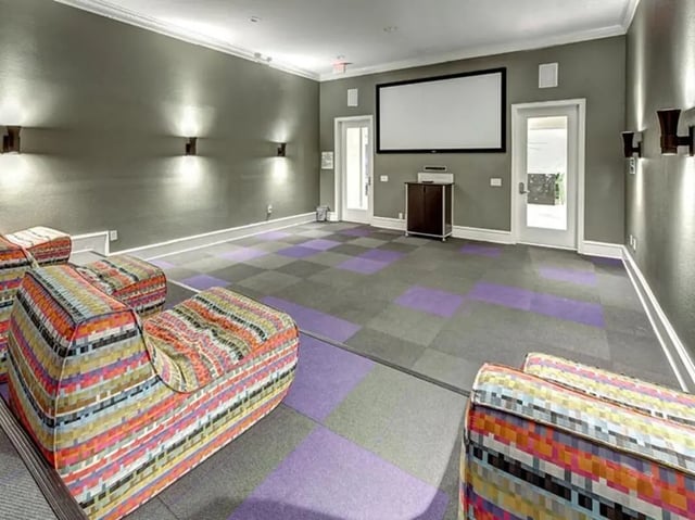 Colorful modular sofas and projector screen movie room at City Parc at Fry Street in Denton Student Accommodation