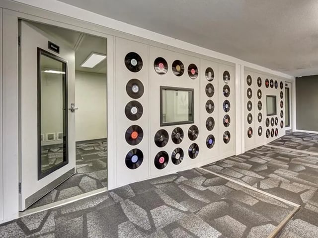 Vinyl records on wall and open door hallway at City Parc at Fry Street in Denton Student Accommodation