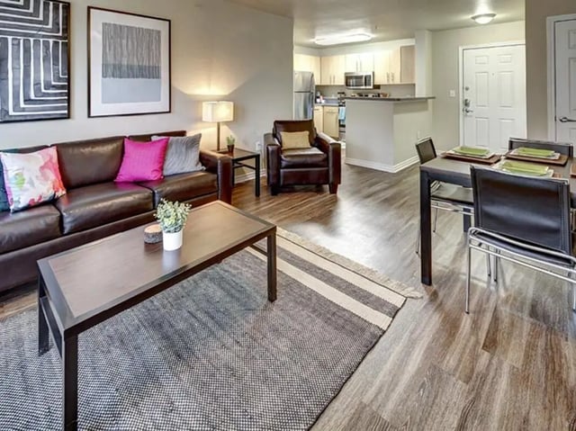 Brown leather sofa dining set kitchen visible living room at City Parc at Fry Street in Denton Student Accommodation
