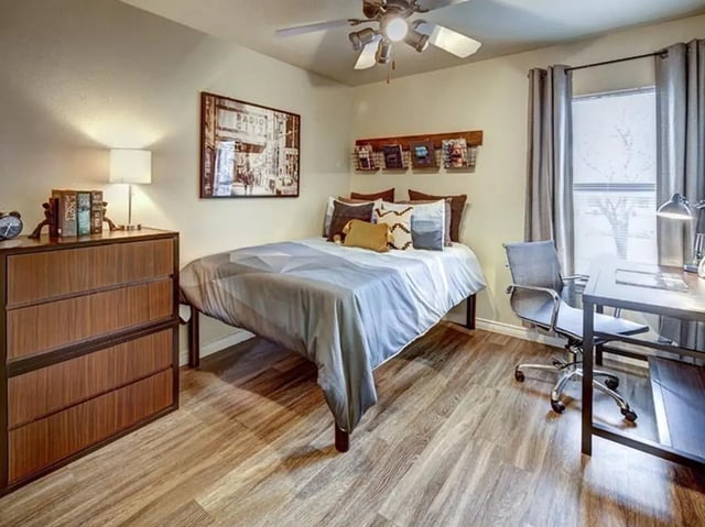Bed dresser desk chair and window bedroom at City Parc at Fry Street in Denton Student Accommodation