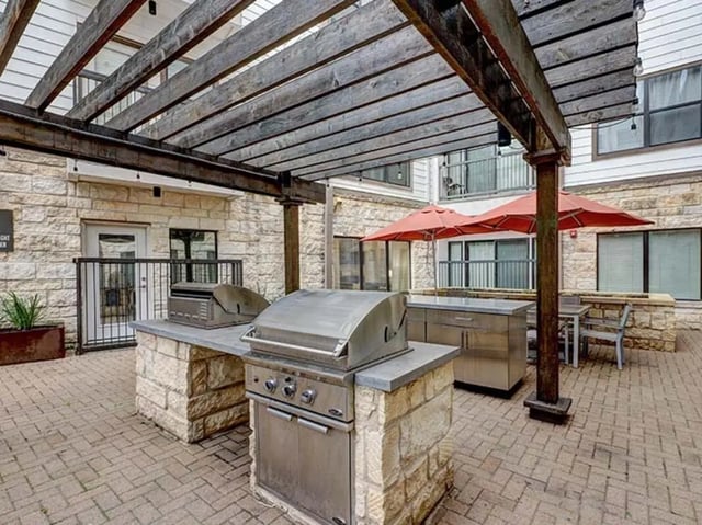 Grills umbrellas tables outdoor amenity area at Crest at Pearl in Austin Student Accommodation