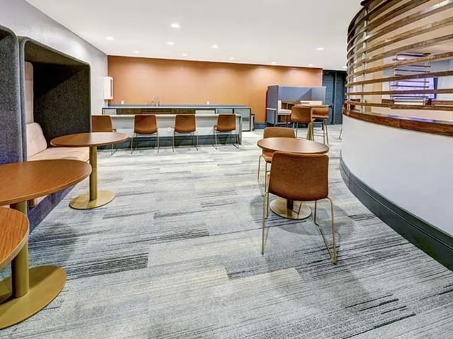 Seating booths tables and chairs common area at Crest at Pearl in Austin Student Accommodation