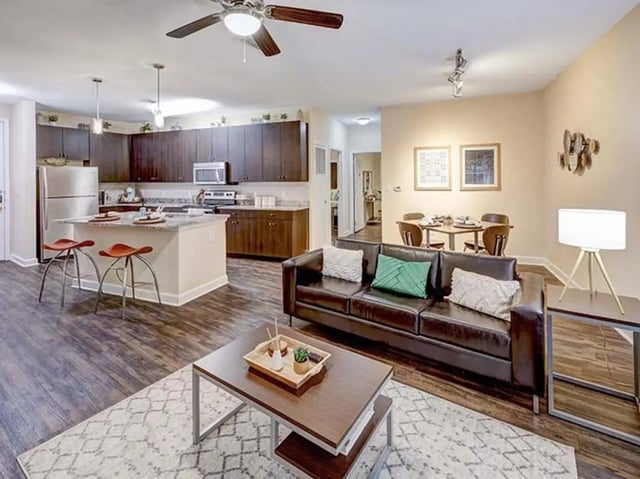 Sofa dining table kitchen island living room at Crest at Pearl in Austin Student Accommodation