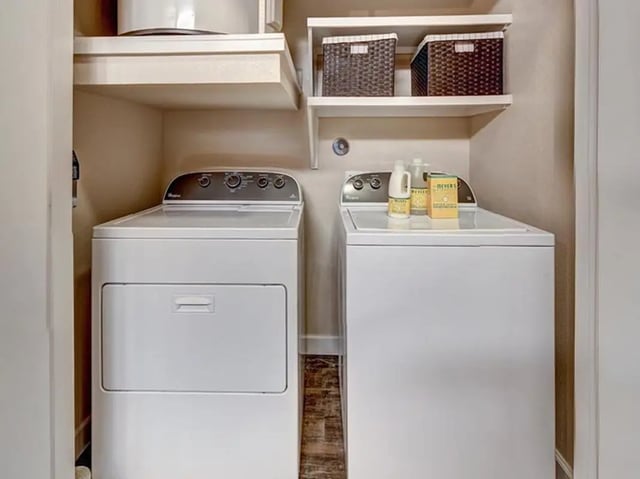 Washer dryer shelves with baskets cleaning supplies laundry room at Crest at Pearl in Austin Student Accommodation