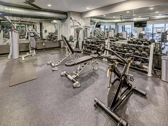 Dumbbells weights bench and exercise bike gym at Crest at Pearl in Austin Student Accommodation
