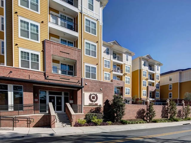 Apartment building with brick and yellow exterior Exterior at 601 Copeland in Tallahassee Student Accommodation