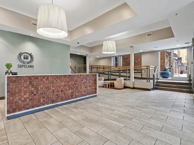 Copeland building reception area with wooden desk lobby at 601 Copeland in Tallahassee Student Accommodation