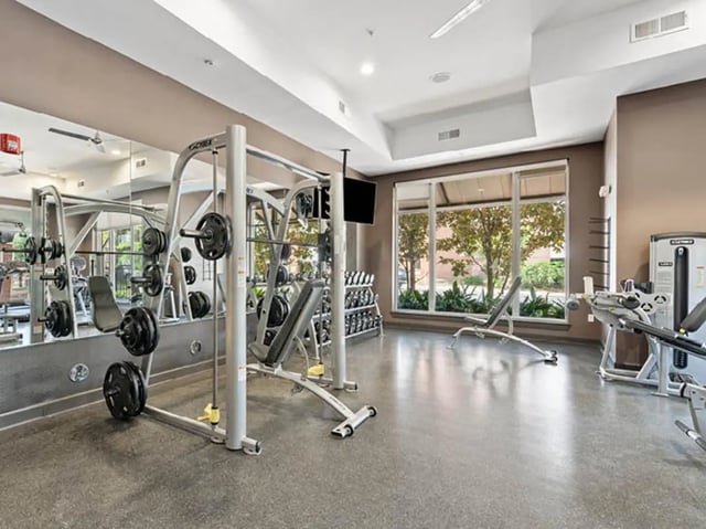 Weight rack bench and gym equipment fitness room at 601 Copeland in Tallahassee Student Accommodation
