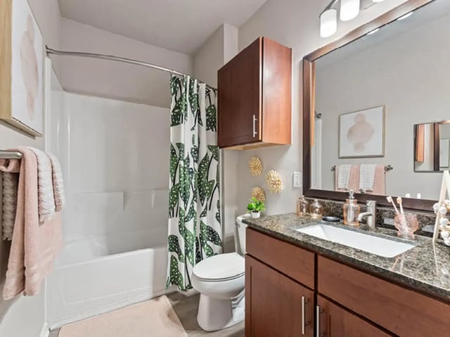 Toilet tub cabinet sink mirror bathroom at 601 Copeland in Tallahassee Student Accommodation