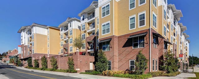 Apartment building with brick and yellow siding exterior. at 601 Copeland in Tallahassee Student Accommodation