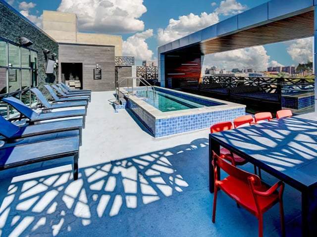 Lounge chairs pool and dining table area exterior at Campus Edge Ann Arbor in Ann Arbor Student Accommodation