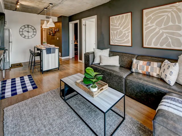 Leather sofa kitchen island and coffee table living room at Campus Edge Ann Arbor in Ann Arbor Student Accommodation
