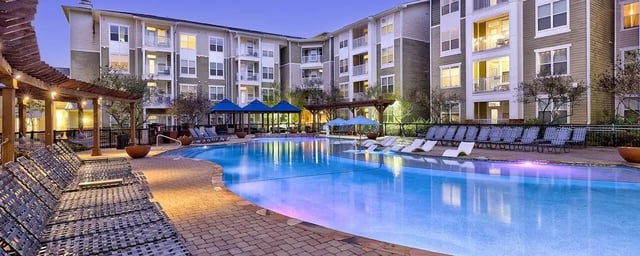 Apartment complex with swimming pool and lounge chairs exterior at 160 Ross in Auburn Student Accommodation