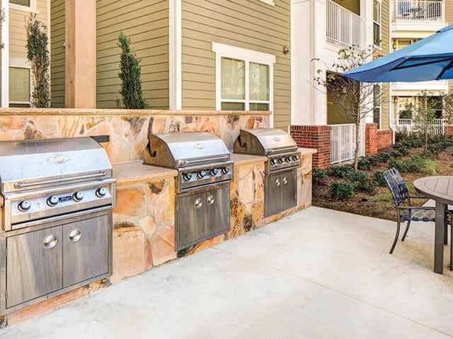 Three stainless steel grills on stone counter exterior at 160 Ross in Auburn Student Accommodation