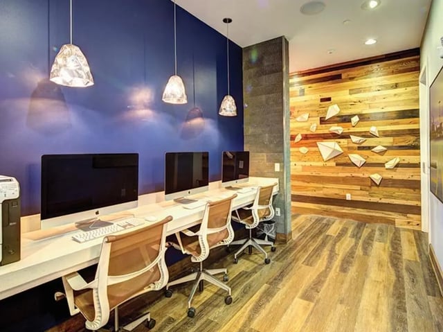Computers and chairs at a long desk study area at 160 Ross in Auburn Student Accommodation
