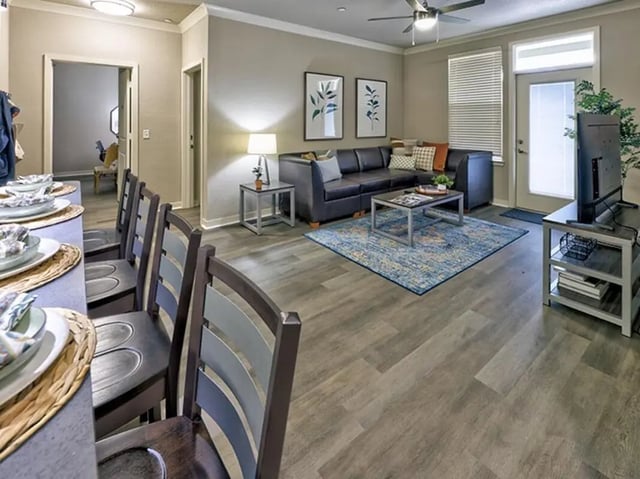 Chairs table and sectional sofa living room at 160 Ross in Auburn Student Accommodation