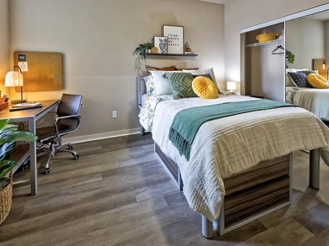 Bed desk chair and closet bedroom at 160 Ross in Auburn Student Accommodation