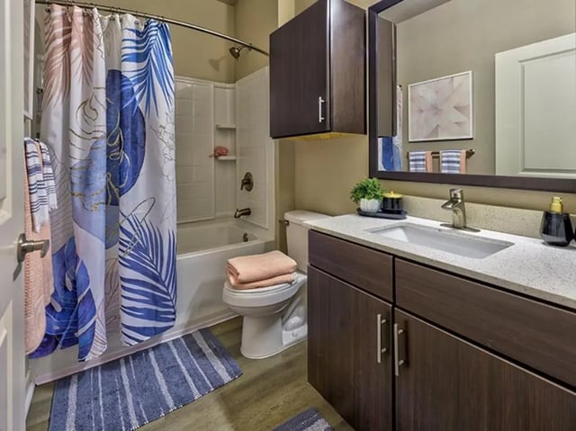Floral shower curtain toilet sink and vanity bathroom at 160 Ross in Auburn Student Accommodation