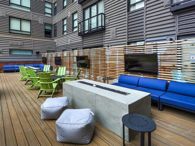 Modern outdoor seating with blue sofas living room at Campus Edge on Pierce in West Lafayette Student Accommodation