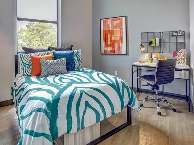 Bed with pillows desk and chair bedroom at Campus Edge on Pierce in West Lafayette Student Accommodation