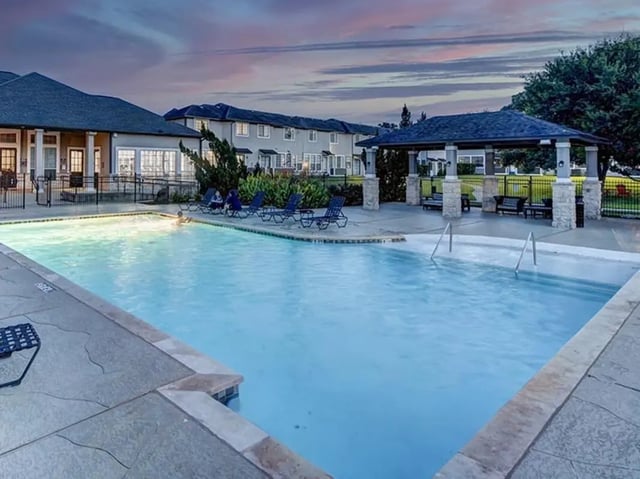 Pool with lounge chairs and gazebo exterior at Bishops Square in San Marcos Student Accommodation