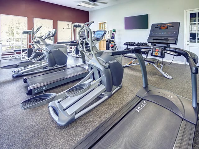 Gym equipment including treadmills and ellipticals fitness room at Bishops Square in San Marcos Student Accommodation