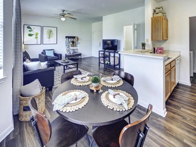 Round dining table with place settings living room kitchen at Bishops Square in San Marcos Student Accommodation